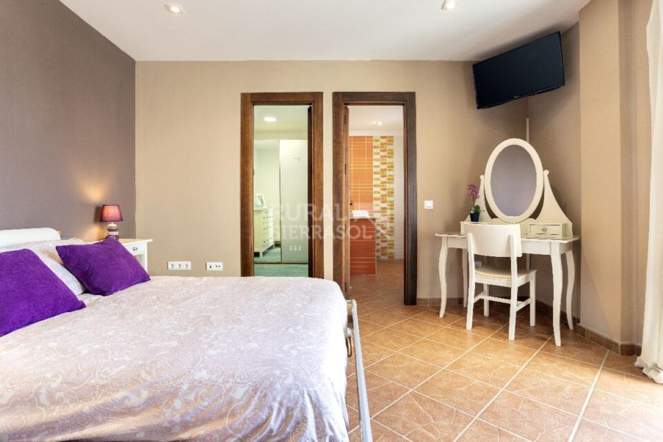 Dormitorio con cama de matrimonio y TV de Casa rural en Alcaucín (Málaga)-4035